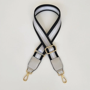 Adjustable black shoulder strap with silver glitter stripes and gold metal clasps
