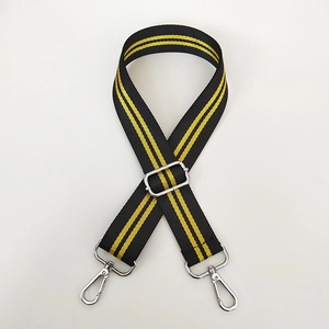 Detail of adjustable black and yellow striped shoulder strap with silver swivel hooks