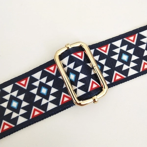 Macro shot of colorful geometric woven strap with premium gold metal adjustment buckle