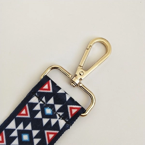 Close-up of adjustable woven shoulder strap with blue and red ethnic geometric pattern