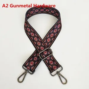 Detail of adjustable ethnic geometric woven shoulder strap with gunmetal hardware hooks