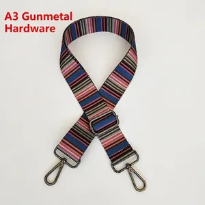 Close-up of adjustable woven canvas strap with ethnic pattern and gunmetal hardware