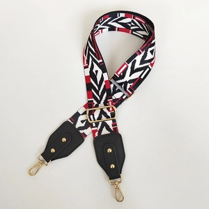 Detail view of ethnic red and black canvas strap with gold swivel lobster clasps