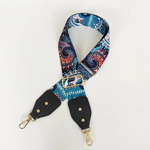 Detail of adjustable paisley canvas strap with metal swivel hooks for handbags