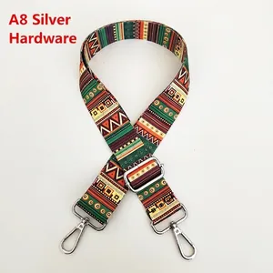 Detail of adjustable wide shoulder strap featuring ethnic patterns and silver hardware