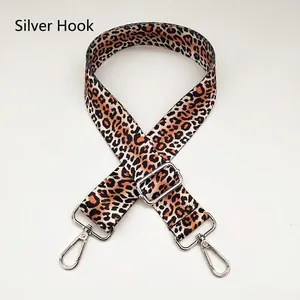 Close-up of leopard print 3.8cm wide bag strap with silver metal hooks and buckle