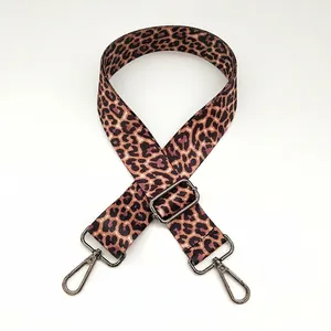 Detail view of leopard print bag strap with adjustable gunmetal buckle and lobster clasps