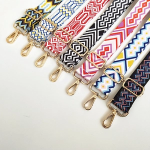 Detail showing various patterned canvas bag straps with gold metal adjustment buckles