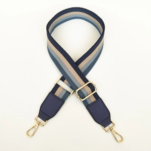 Verstelbare brede tasriem met blauw-beige strepen en goudkleurige musketonhaken