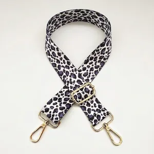 Close-up of leopard print shoulder strap with gold metal hooks and adjustable buckle