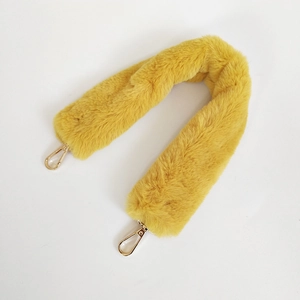 Close-up of ginger yellow faux rabbit fur bag strap with gold metal lobster clasps