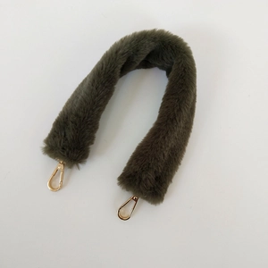 Detail of soft faux fur olive green shoulder strap with golden metal lobster clasps