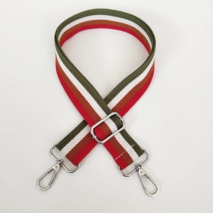 Detail of adjustable wide canvas shoulder strap with colorful stripes and silver metal hooks