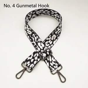 Close-up of black and white leopard print bag strap with gunmetal hardware and hooks