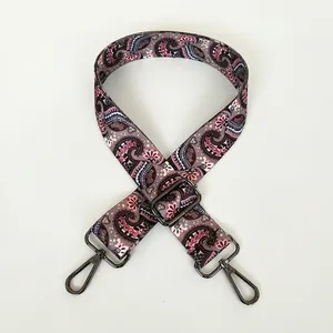 Close-up of adjustable wide shoulder strap with vintage colorful paisley pattern and gunmetal hooks