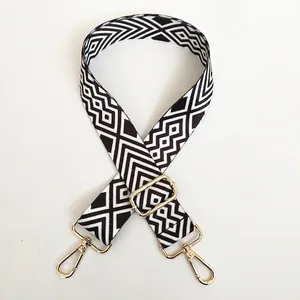 Adjustable wide canvas shoulder strap with black white geometric patterns and gold hooks