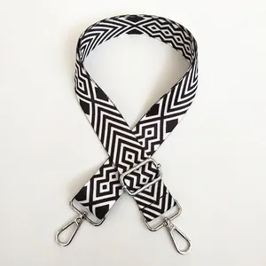 Detail of A15 wide canvas shoulder strap with black and white geometric pattern and silver hook