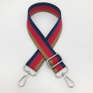 Detail of adjustable woven shoulder strap with colorful stripes and silver metal buckles