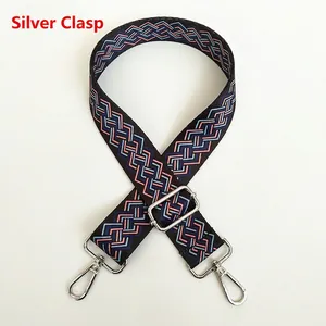 Detail of adjustable wide canvas shoulder strap with blue and pink wave patterns and silver hooks