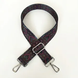 Close-up of adjustable purse strap with purple bohemian heart patterns and silver hooks