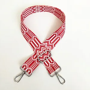 Detail of silver hook and red geometric ethnic patterned wide canvas replacement bag strap
