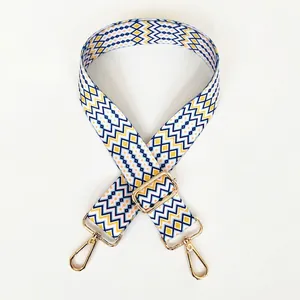 Detail of colorful geometric woven strap with adjustable gold lobster clasp
