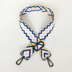 Detail of adjustable geometric strap with colorful patterns and gunmetal hooks