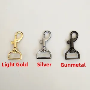 Close-up of swivel lobster clasps in light gold, silver, and gunmetal finishes for bag straps