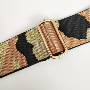 Macro detail of 5cm wide jacquard weave strap with leopard pattern and gold buckle