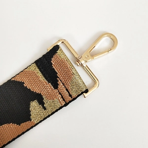 Detail of jacquard camouflage woven strap with polished gold lobster clasp for bags
