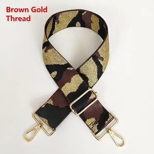 Detail of camoufalge jacquard strap with golden metallic thread and swivel hooks