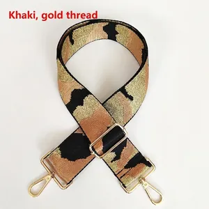 Detail of khaki camouflage webbing strap with gold thread and metal swivel hook buckle