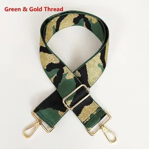 Detail view of camouflage nylon bag strap with gold thread and golden metal buckles