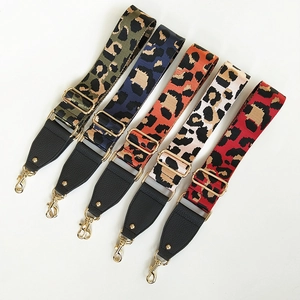 Detail showing five leopard print crossbody straps with leather ends and gold metal hooks