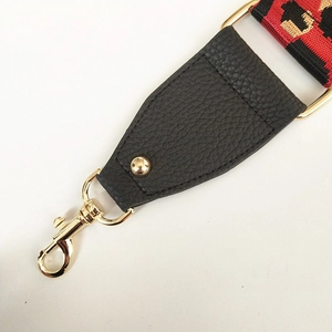 Detail of leopard print bag strap with golden lobster clasp and lychee leather attachment