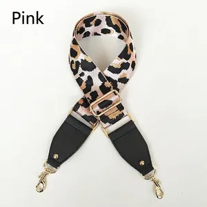 Close-up of pink leopard print wide strap with black lychee leather and gold hardware