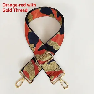 Detail of adjustable orange and blue camo bag strap with gold thread and metal hardware