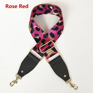 Detail of rose red leopard print wide bag strap with gold metal hooks and leather ends
