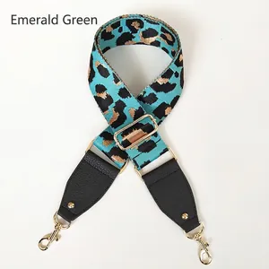 Detail of adjustable emerald green leopard print bag strap with gold metal hooks