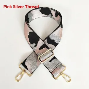 Macro detail of camouflage patterned pink jacquard replacement strap with gold metal buckle