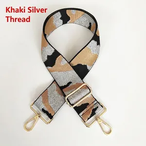 Detail of khaki silver thread camouflage bag strap with polished gold metal hardware