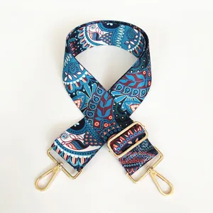 Detail of bohemian canvas purse strap with ethnic patterns and gold metal lobster clasps