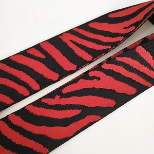 Close-up of red and black tiger pattern jacquard woven strap with durable texture
