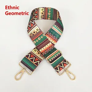 Close-up of geometric ethnic canvas bag strap with golden metal swivel hooks and buckles