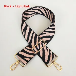 Adjustable black and light pink zebra print replacement shoulder strap with gold hooks