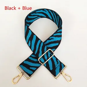 Adjustable zebra print strap in black and blue with gold metal swivel hooks for bags