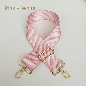 Detailed view of pink and white zebra pattern strap with golden metal swivel hooks