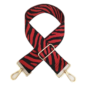 Adjustable red and black zebra print wide shoulder strap with gold metal hardware hooks