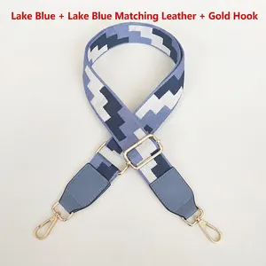 Adjustable canvas bag strap in blue geometric pattern with gold metal hooks and leather