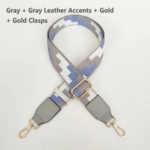 Detail of adjustable woven purse strap with grey geometric pattern and gold hardware hooks